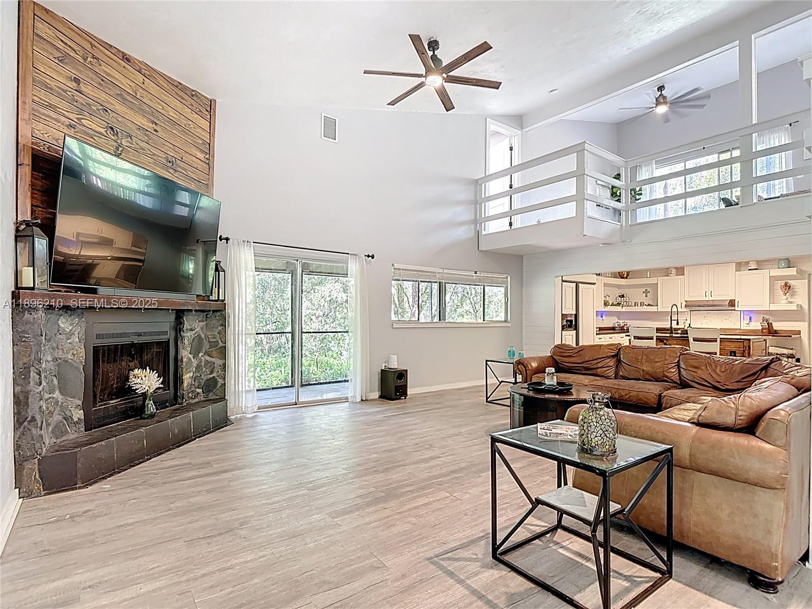 1270 Tom Coker Road LaBelle, FL 33935 - Photo 8 of 46 a living room with furniture a flat screen tv and a fireplace