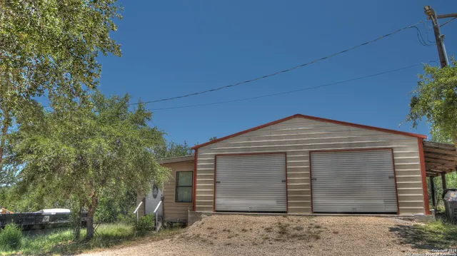a view of a house with a tree