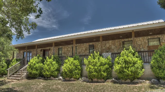 a front view of a house with plants