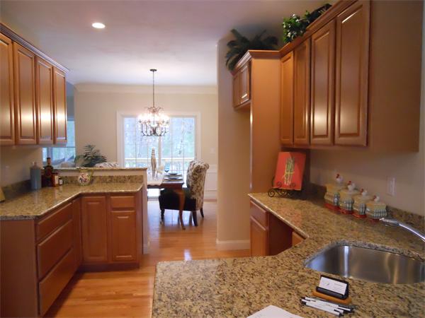 26 Sanctuary Lane, Unit 26 Hopkinton, MA 01748 - Photo 2 of 10 a kitchen with stainless steel appliances granite countertop a sink stove and refrigerator