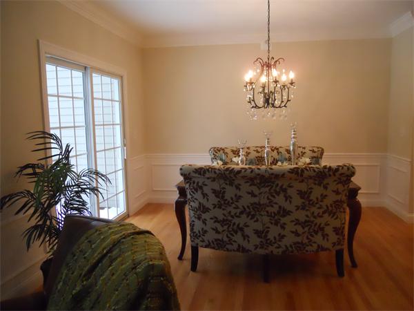26 Sanctuary Lane, Unit 26 Hopkinton, MA 01748 - Photo 7 of 10 a view of a dining room with furniture and chandelier
