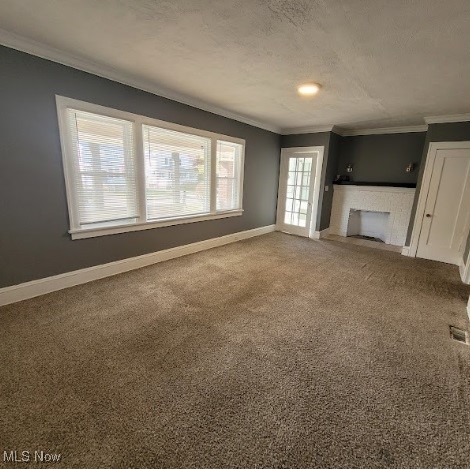 18225 Landseer Road Cleveland, OH 44119 - Photo 11 of 12 Unfurnished living room featuring carpet floors, crown molding, a textured ceiling, and a fireplace