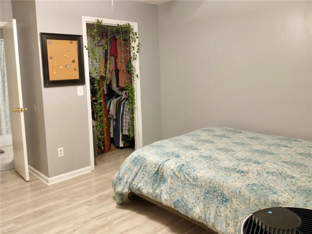 766 Country Club Road Newnan, GA 30263 - Photo 26 of 34 Bedroom featuring wood finished floors and a spacious closet