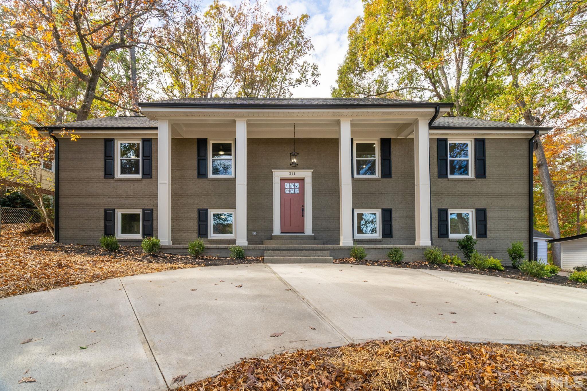 311 Lord Ashley Road Raleigh, NC 27610 - Photo 1 of 39 a front view of a house with a yard