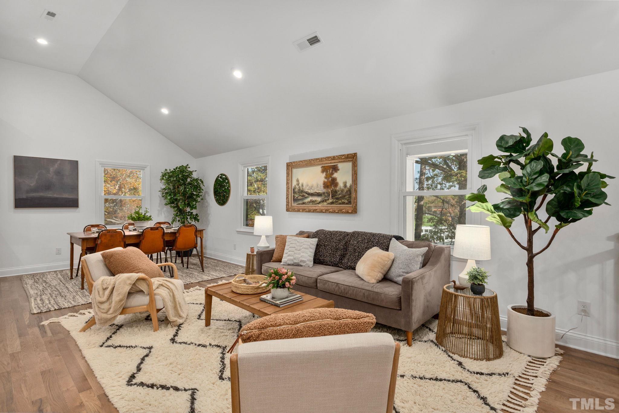 311 Lord Ashley Road Raleigh, NC 27610 - Photo 11 of 39 a living room with furniture potted plant and a lamp