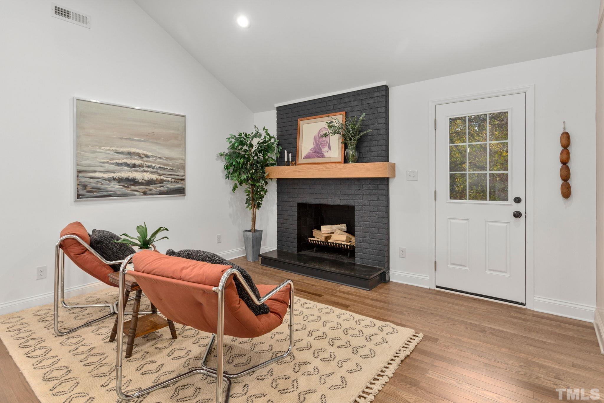 311 Lord Ashley Road Raleigh, NC 27610 - Photo 13 of 39 a living room with furniture and a fireplace