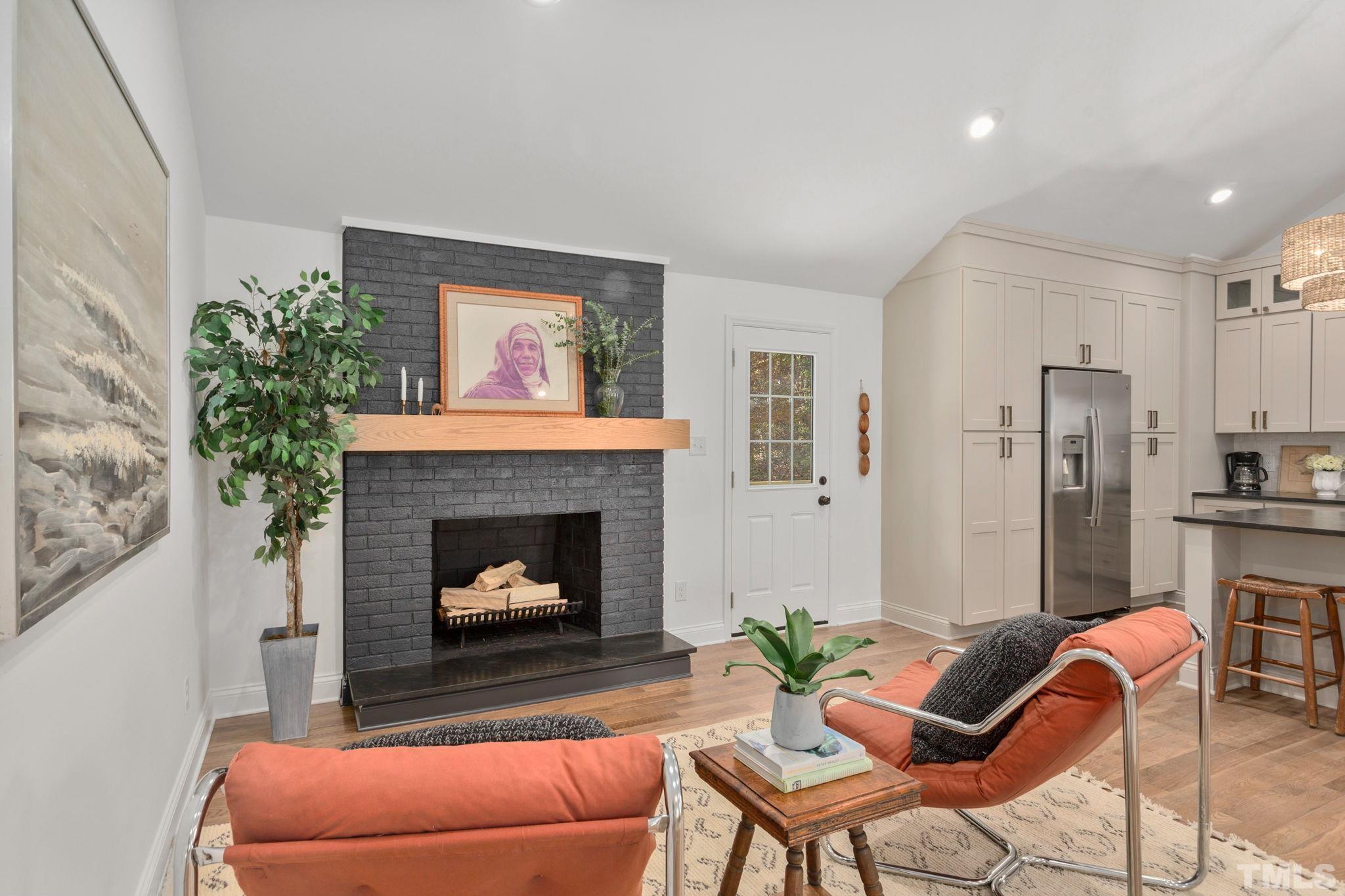 311 Lord Ashley Road Raleigh, NC 27610 - Photo 14 of 39 a living room with furniture and a fireplace