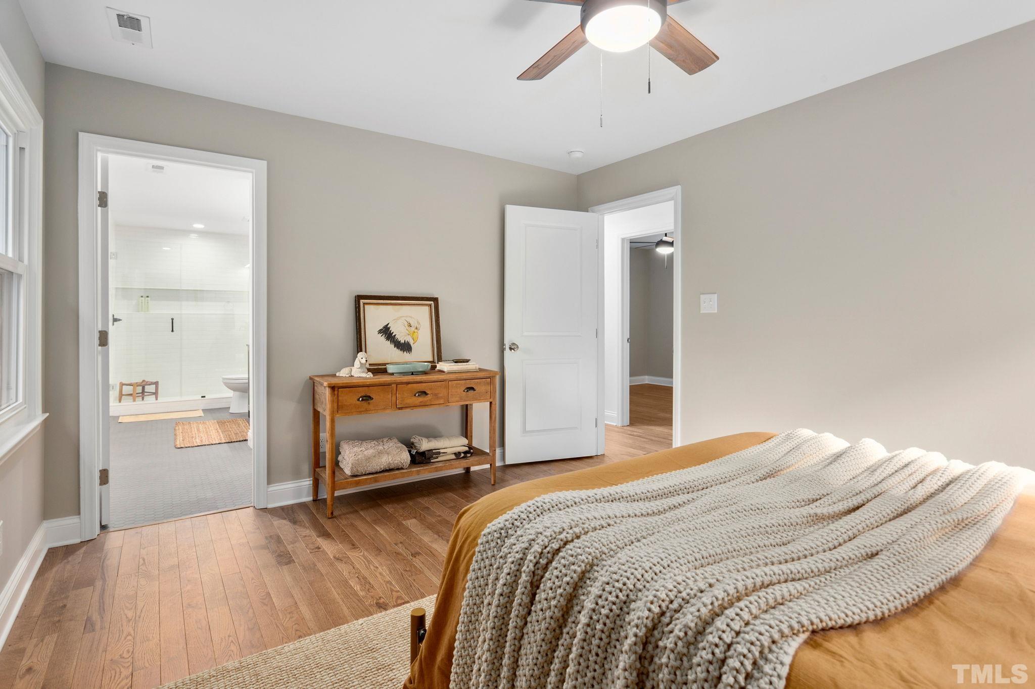 311 Lord Ashley Road Raleigh, NC 27610 - Photo 16 of 39 a bedroom with a bed and a chandelier