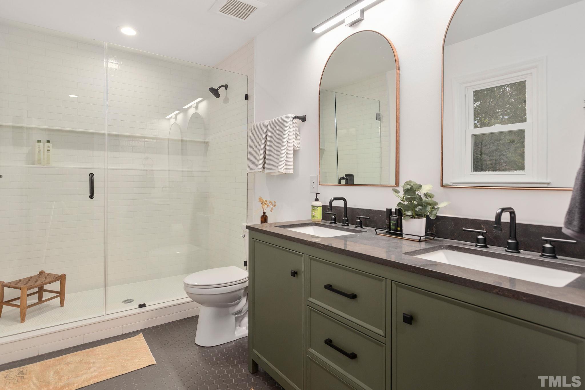 311 Lord Ashley Road Raleigh, NC 27610 - Photo 17 of 39 a bathroom with a double vanity sink toilet and shower