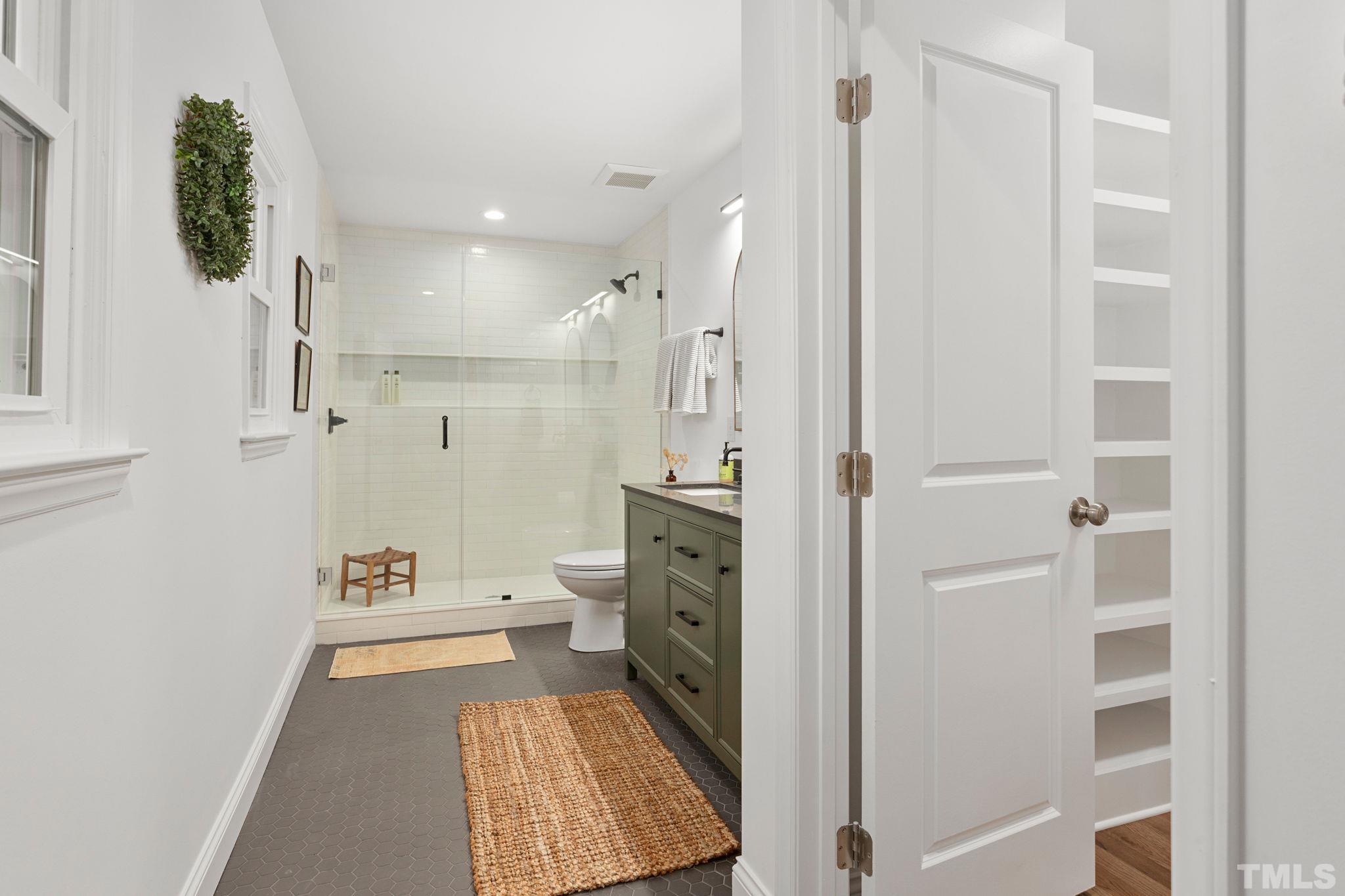 311 Lord Ashley Road Raleigh, NC 27610 - Photo 18 of 39 a bathroom with a sink a toilet and shower