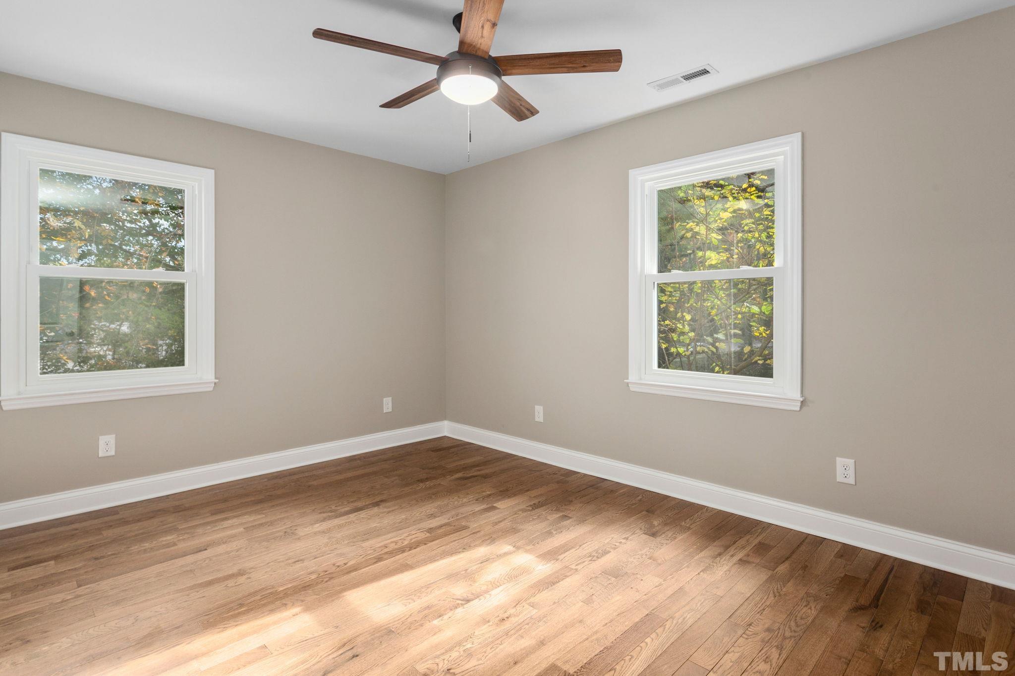 311 Lord Ashley Road Raleigh, NC 27610 - Photo 20 of 39 a view of an empty room with a window and wooden floor