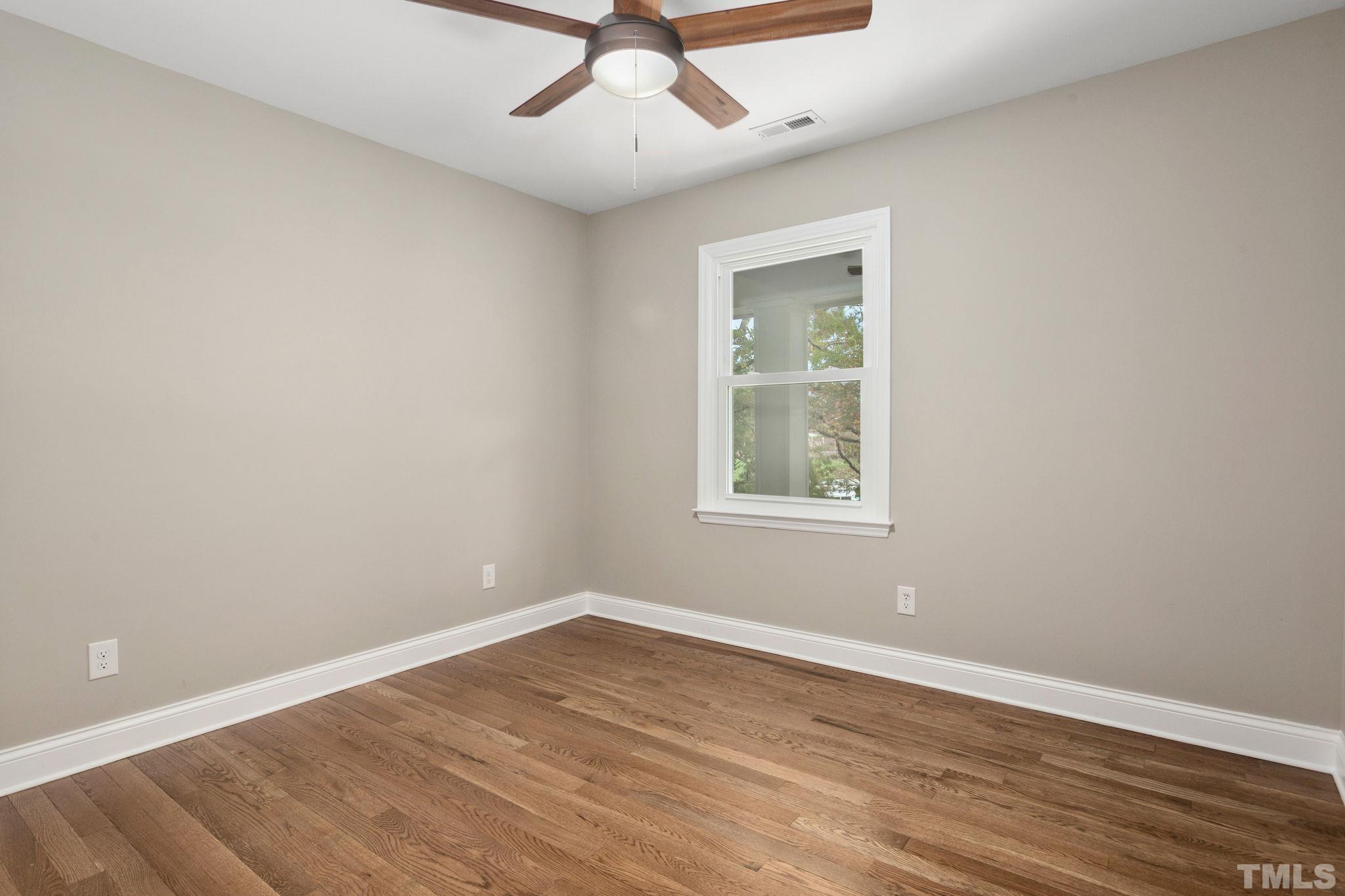 311 Lord Ashley Road Raleigh, NC 27610 - Photo 21 of 39 wooden floor in an empty room with a window