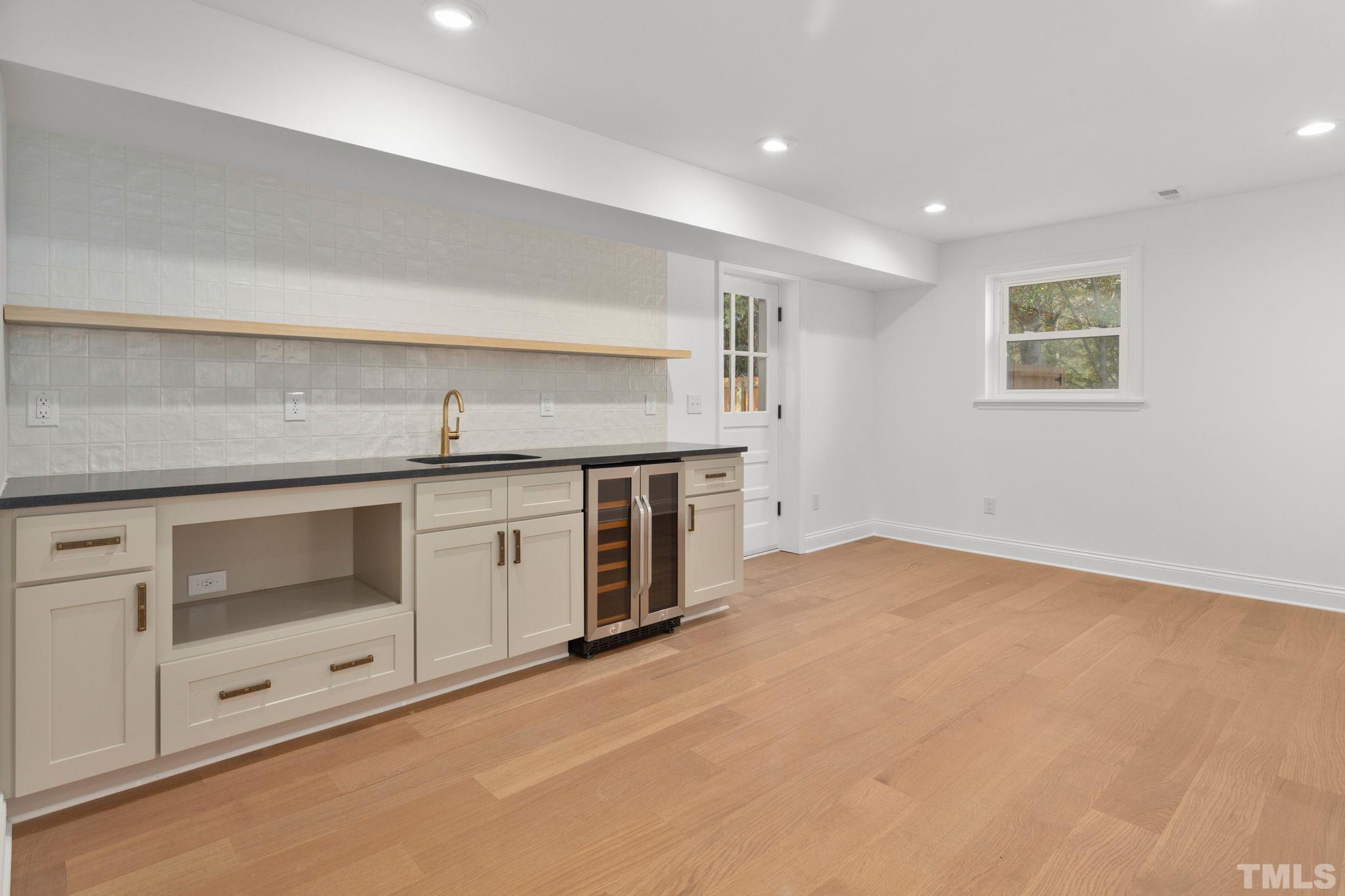 311 Lord Ashley Road Raleigh, NC 27610 - Photo 23 of 39 a kitchen with a stove and a sink