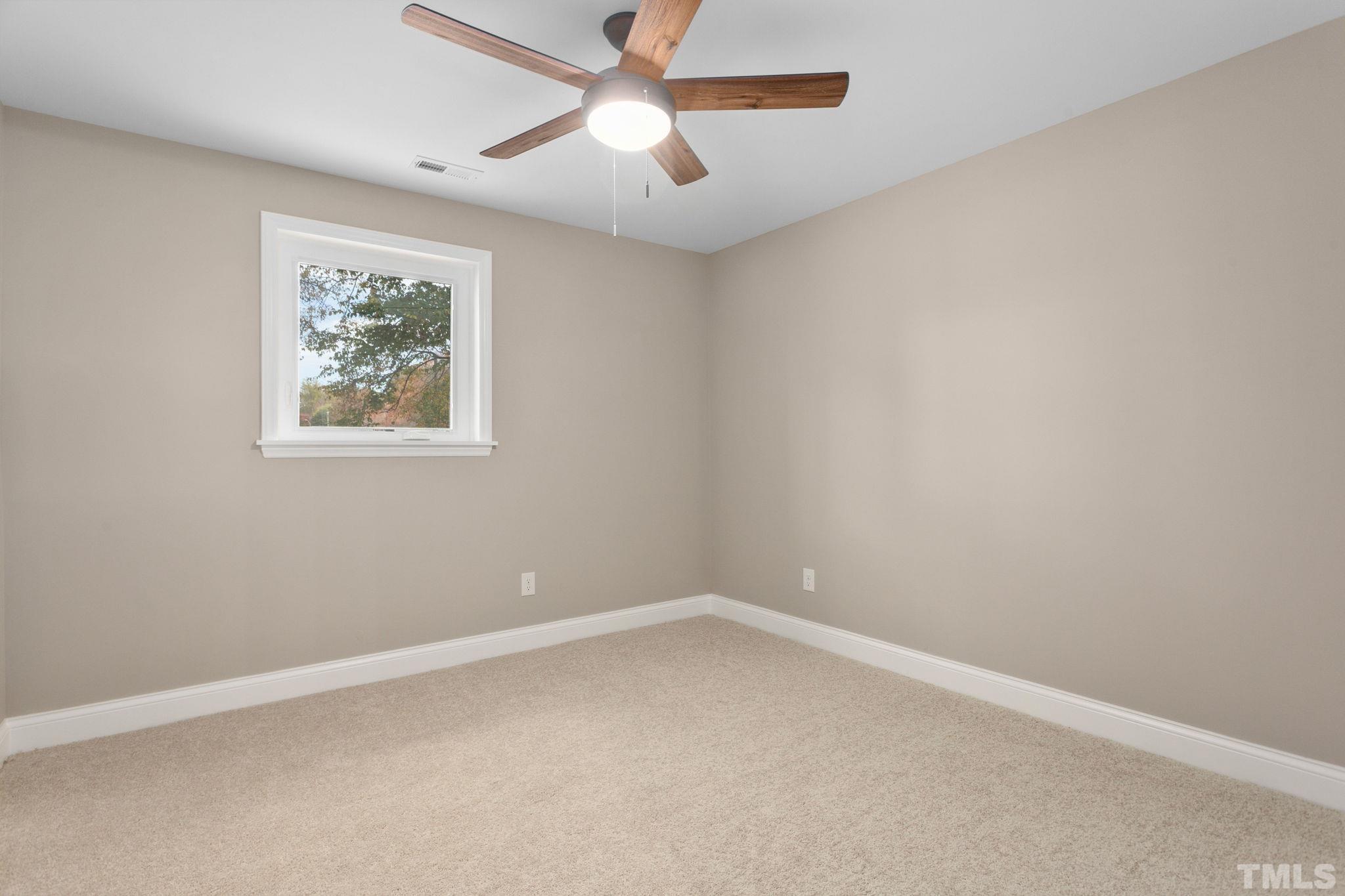 311 Lord Ashley Road Raleigh, NC 27610 - Photo 30 of 39 an empty room with a window and a fan