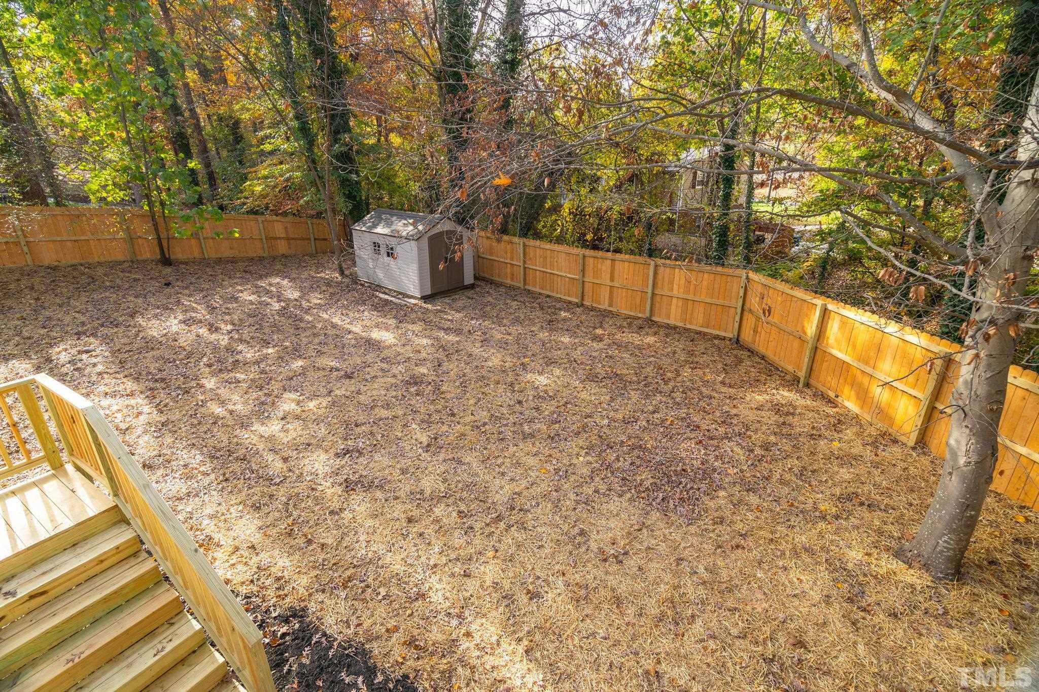 311 Lord Ashley Road Raleigh, NC 27610 - Photo 37 of 39 a backyard of a house with lots of green space