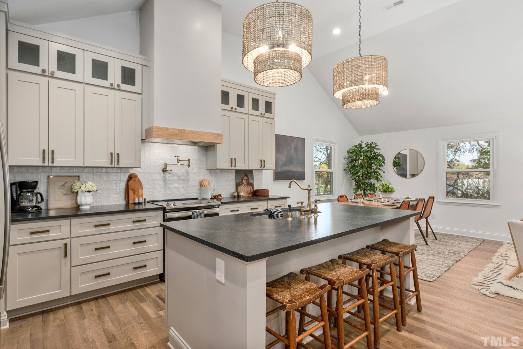 311 Lord Ashley Road Raleigh, NC 27610 - Photo 5 of 39 a kitchen with cabinets appliances and a counter top