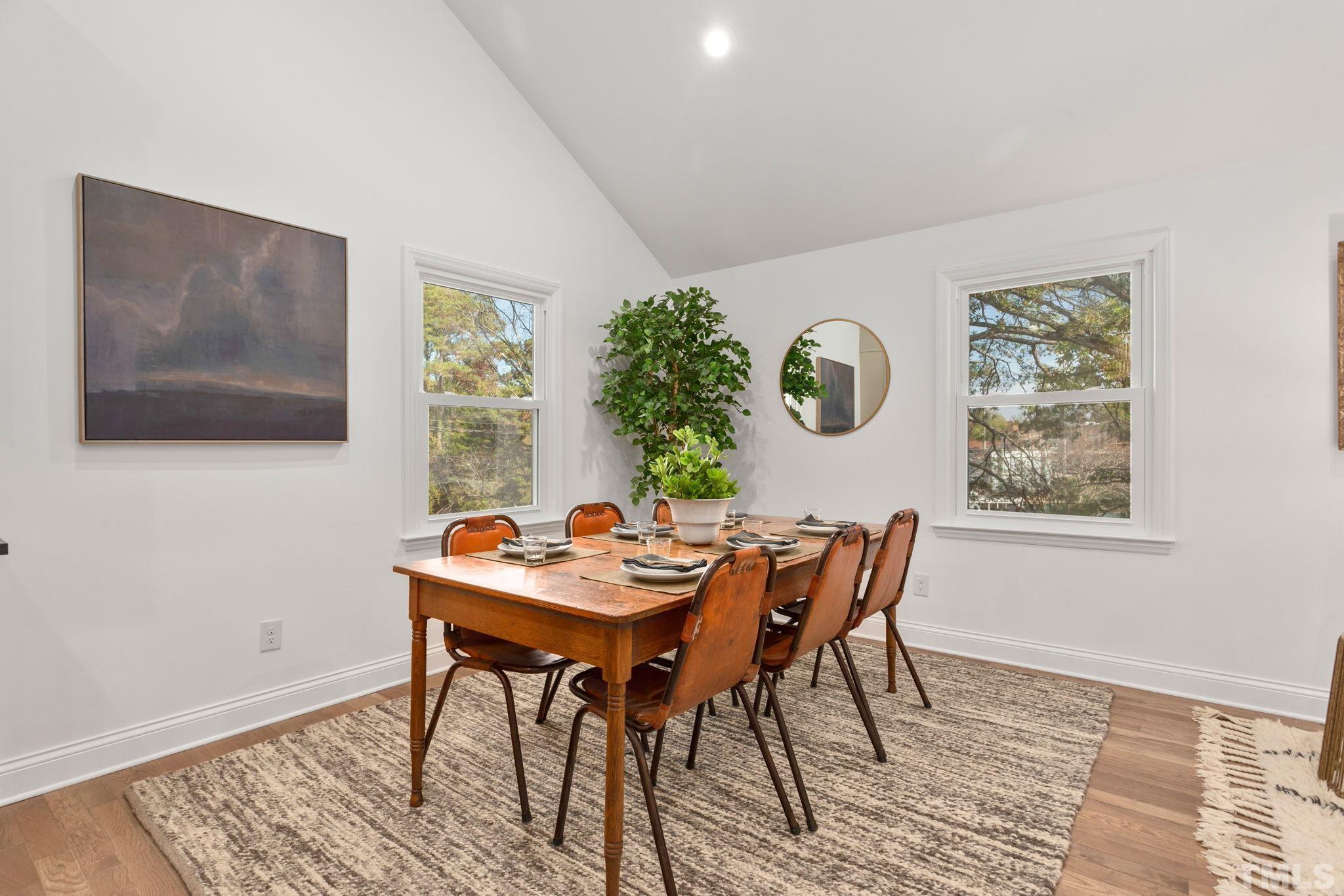311 Lord Ashley Road Raleigh, NC 27610 - Photo 9 of 39 a dining room with furniture and wooden floor