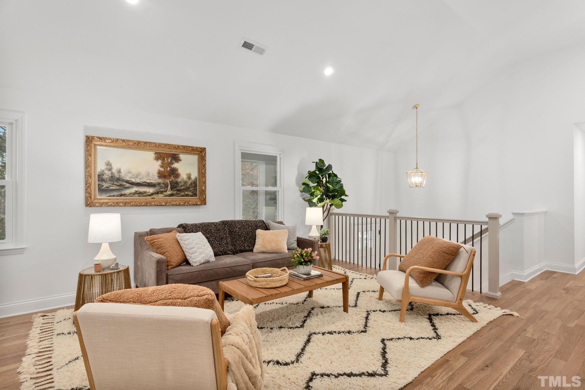 311 Lord Ashley Road Raleigh, NC 27610 - Photo 10 of 39 a living room with furniture a couch and a potted plant