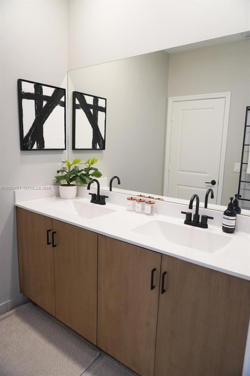 11942 Southwest 243rd Street Homestead, FL 33032 - Photo 30 of 50 a bathroom with a double vanity sink and mirror