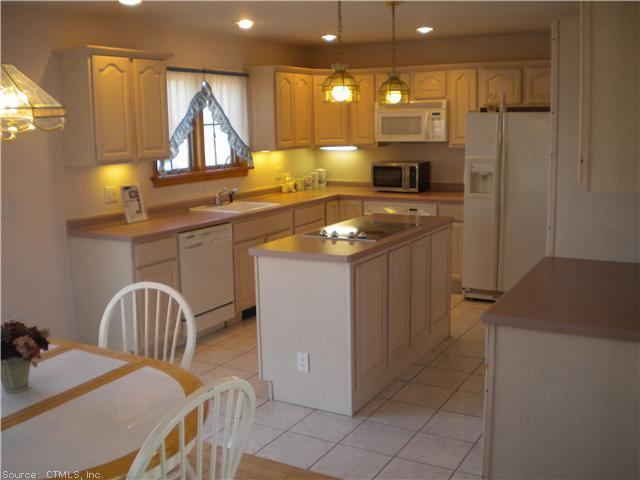 a kitchen with a sink a stove and a refrigerator