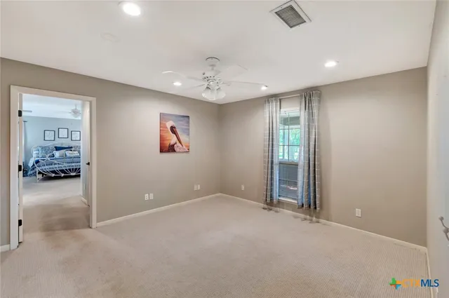 an empty room with windows and closet