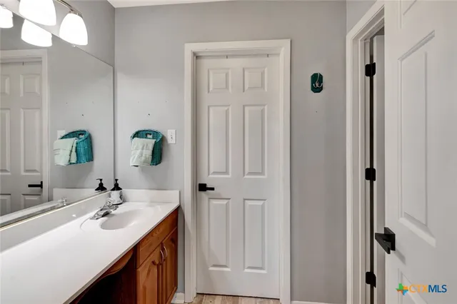 a bathroom with a double vanity sink and a mirror