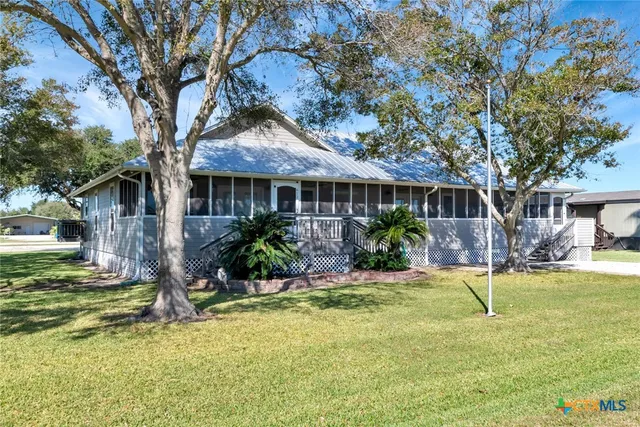 a view of a house with swimming pool and porch with furniture