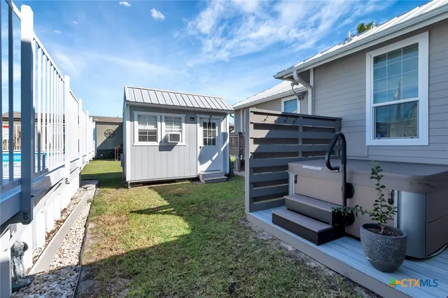 a view of a house with backyard and sitting area