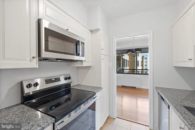 a kitchen with stainless steel appliances granite countertop a stove and a microwave