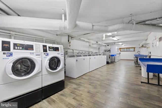 a utility room with dryer washer and stair