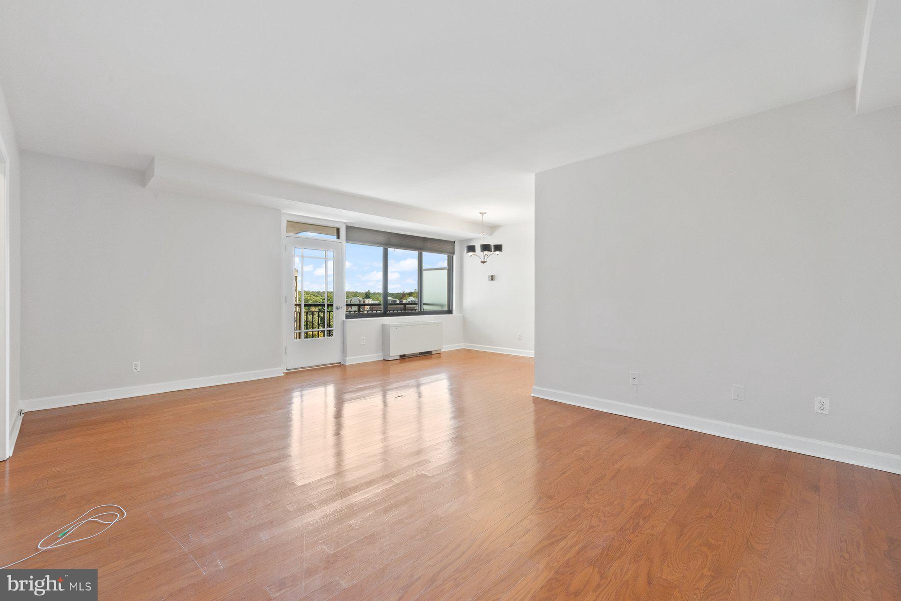 4740 Connecticut Avenue Northwest, Unit 804 Washington, DC 20008 - Photo 4 of 25 wooden floor in an empty room with a window
