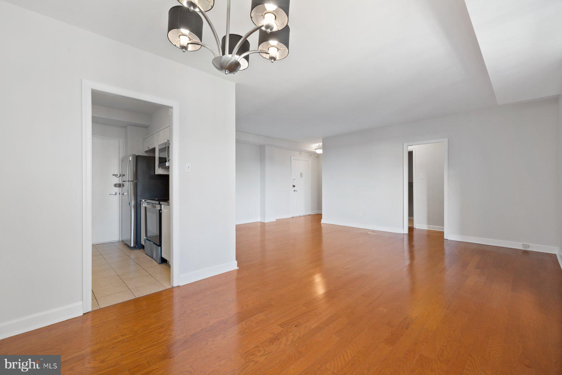 4740 Connecticut Avenue Northwest, Unit 804 Washington, DC 20008 - Photo 9 of 25 a view of an empty room with wooden floor