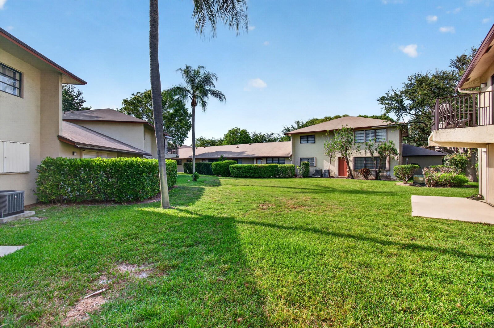 3951 Northeast 19th Road, Unit 1701 Pompano Beach, FL 33064 - Photo 82 of 82 a front view of a house with a yard and palm tree