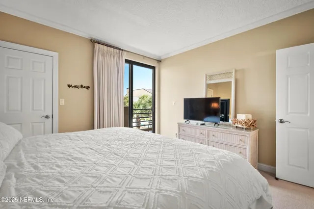 a spacious bedroom with a bed and a window