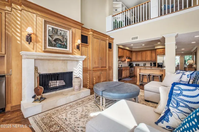 a living room with furniture a fireplace and a flat screen tv