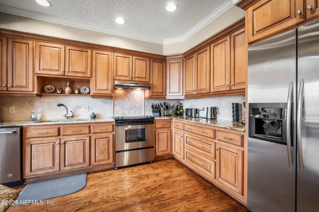 a living room with furniture and a kitchen