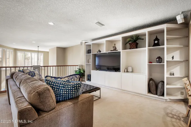a living room with furniture and a rug