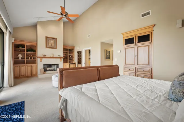 a spacious bedroom with a balcony a bed and a fireplace