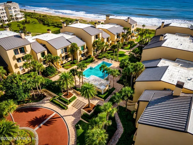 an aerial view of residential houses with outdoor space