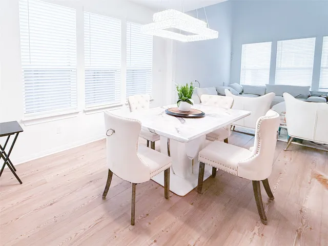 a dining room with furniture and wooden floor