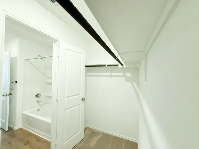 a bathroom with a double vanity sink a toilet and a shower