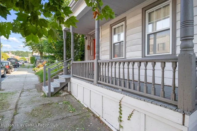 a view of a chair and tables in the balcony