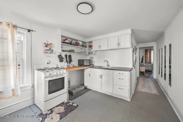 a kitchen with cabinets appliances and a window