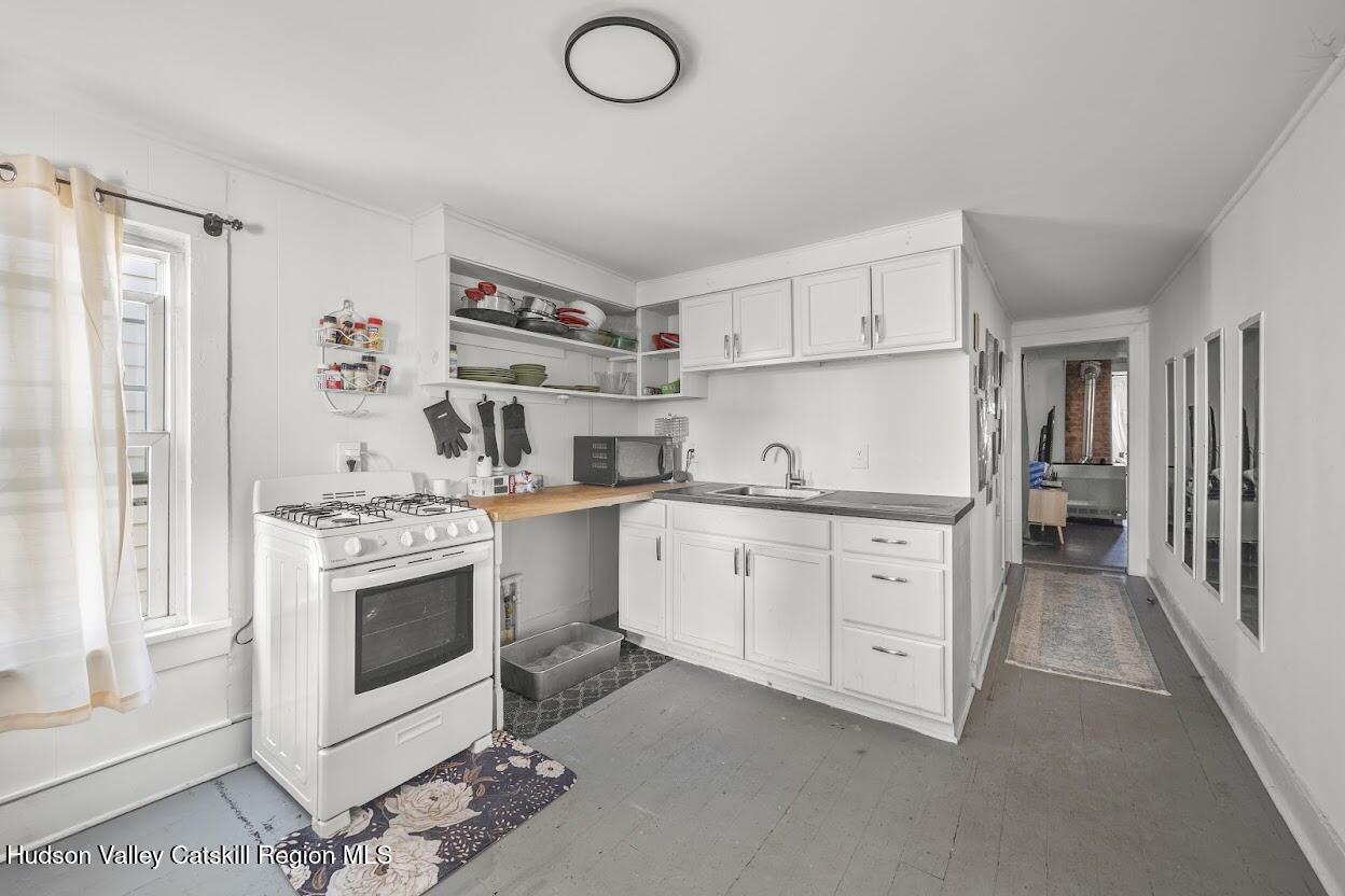 543 State Street, Unit 2 Hudson, NY 12534 - Photo 4 of 22 a kitchen with cabinets appliances and a window