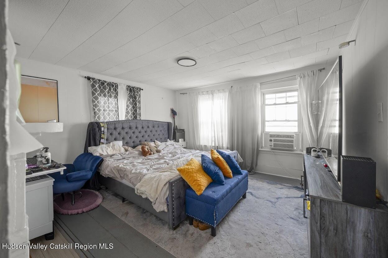 543 State Street, Unit 2 Hudson, NY 12534 - Photo 7 of 22 a bedroom with a bed and wooden floor