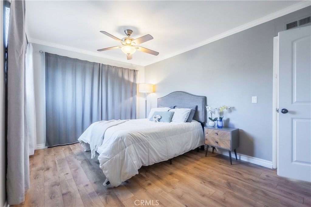 630 South Knott, Unit 14 Anaheim, CA 92804 - Photo 12 of 26 a bedroom with a bed and a chandelier