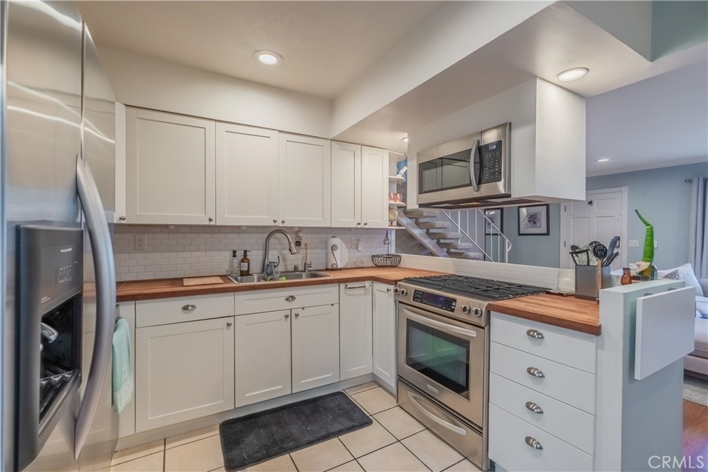630 South Knott, Unit 14 Anaheim, CA 92804 - Photo 8 of 26 a kitchen with stainless steel appliances granite countertop a sink and cabinets