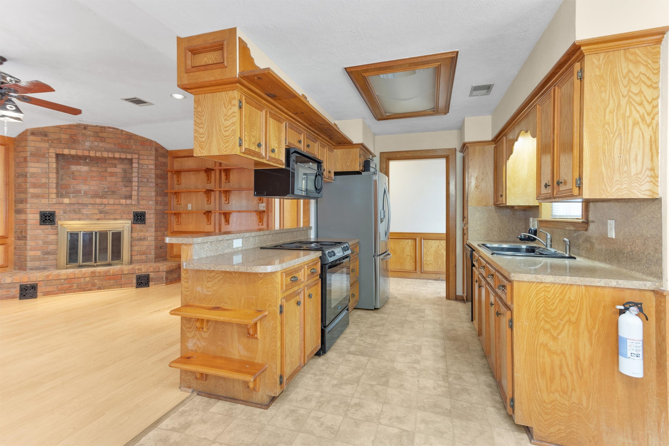 1706 Shawnee Street Navasota, TX 77868 - Photo 11 of 29 a large kitchen with stainless steel appliances granite countertop a large stove a sink and a refrigerator