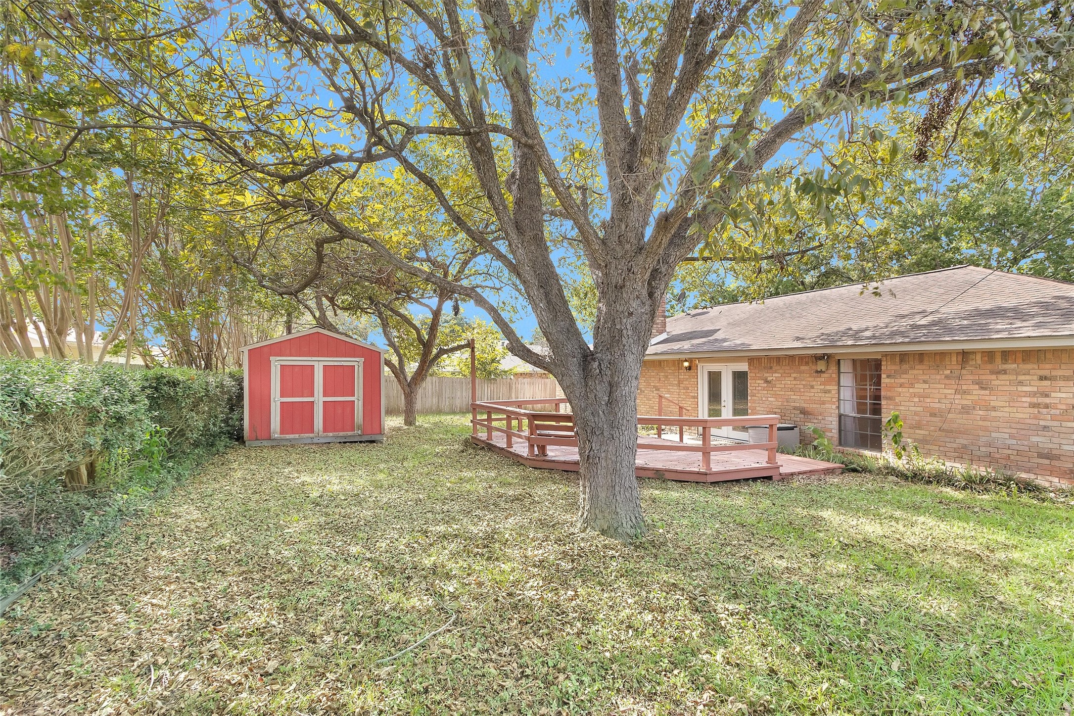 1706 Shawnee Street Navasota, TX 77868 - Photo 28 of 29 a large tree in front of a white house