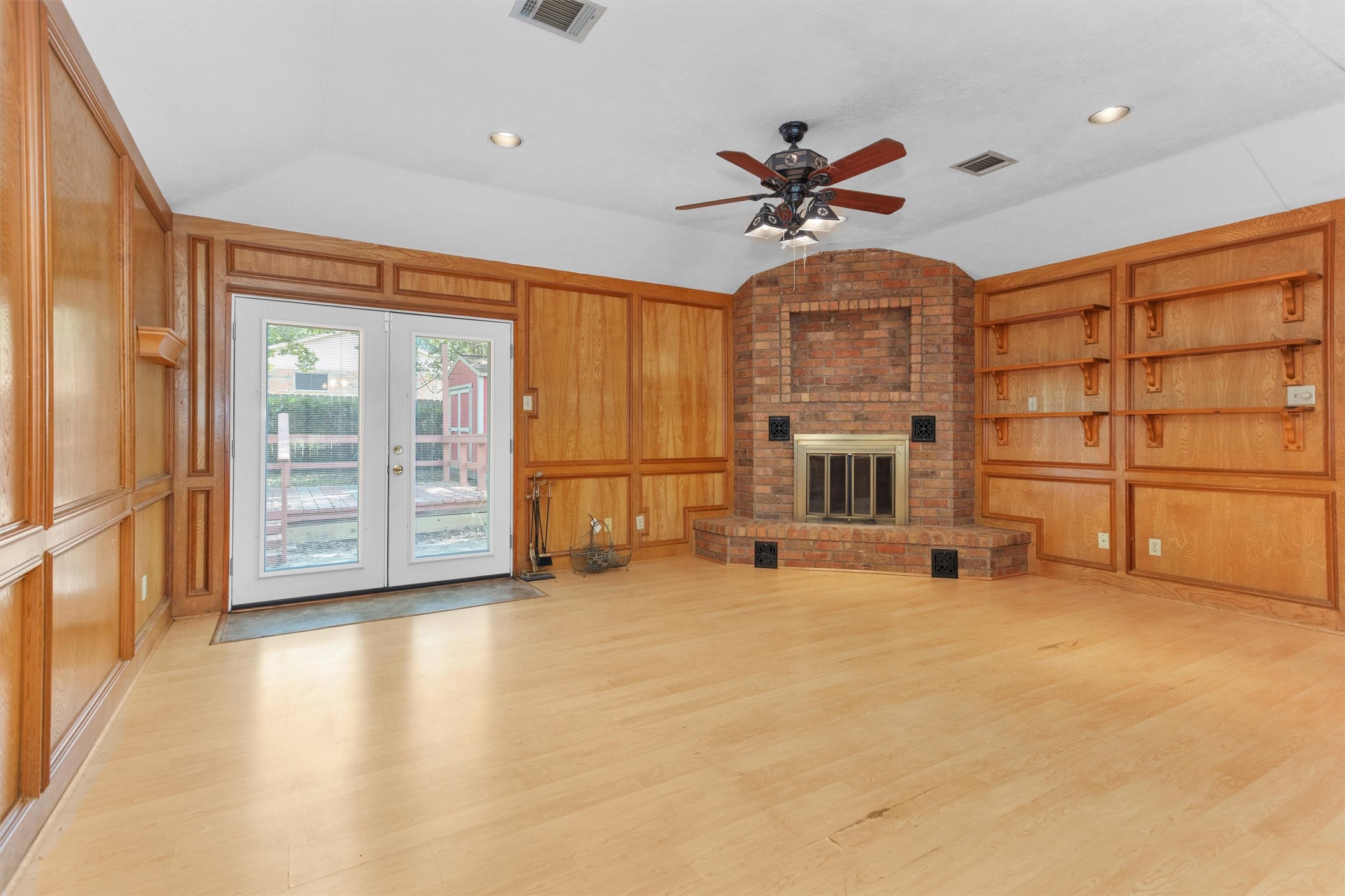 1706 Shawnee Street Navasota, TX 77868 - Photo 7 of 29 a view of a livingroom with a flat screen tv ceiling fan and hardwood floor